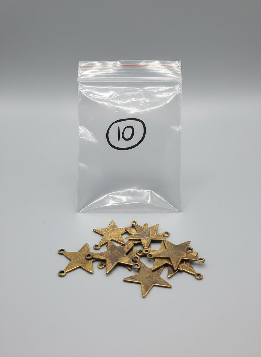 Copper star-shaped charms on a black grid background with a clear bag labeled '10'.