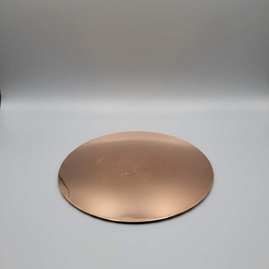 Copper circular object on a gray background