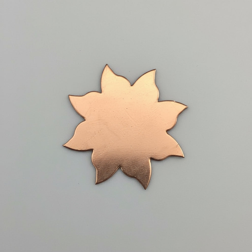 Copper Sun leaf-shaped object on a black grid background