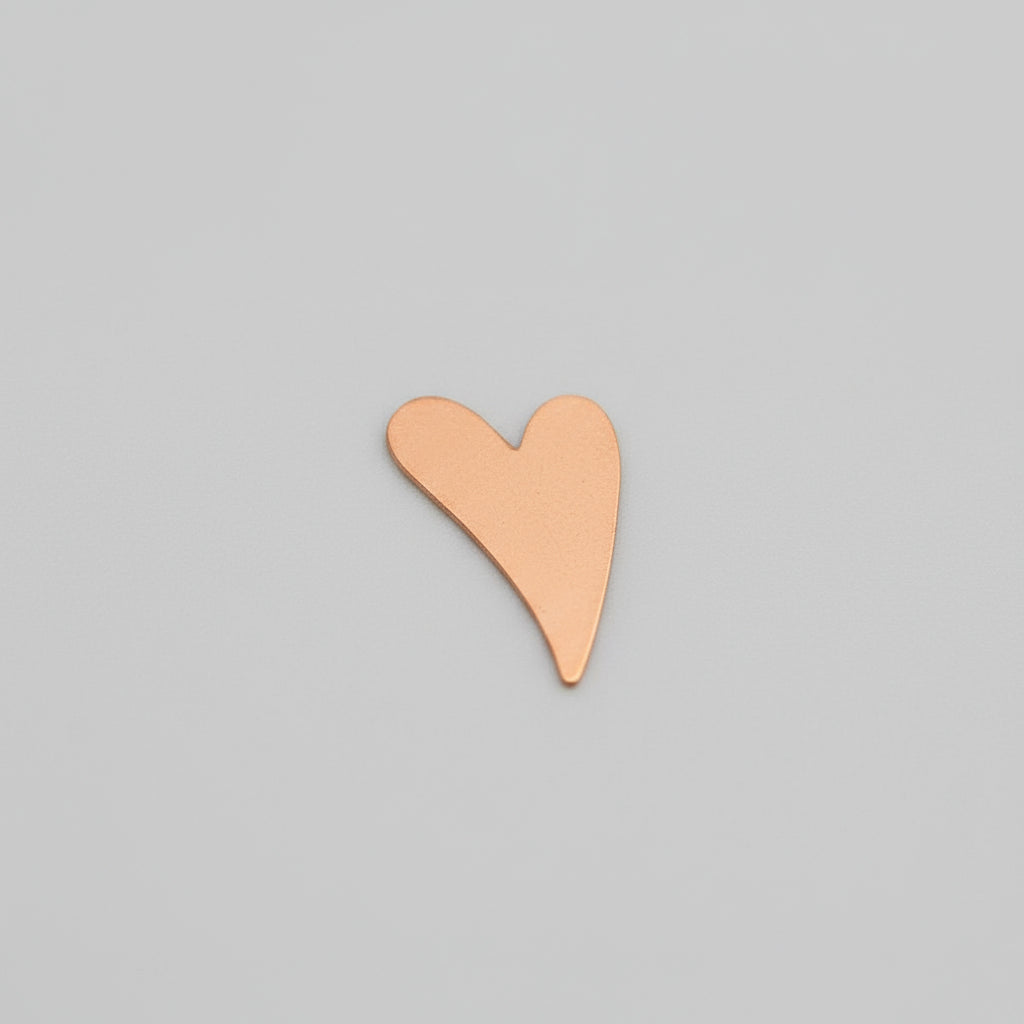 Heart-shaped object on a grid ruler for scale