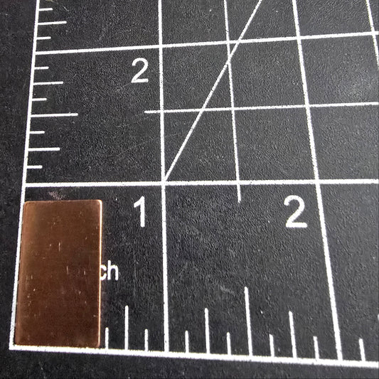 Small rectangular metal object on a grid cutting mat