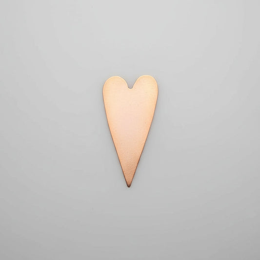 Copper heart-shaped object on a gray background