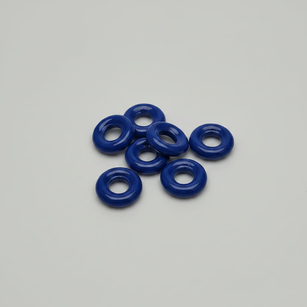 Blue washers on a cutting mat with measurement markings