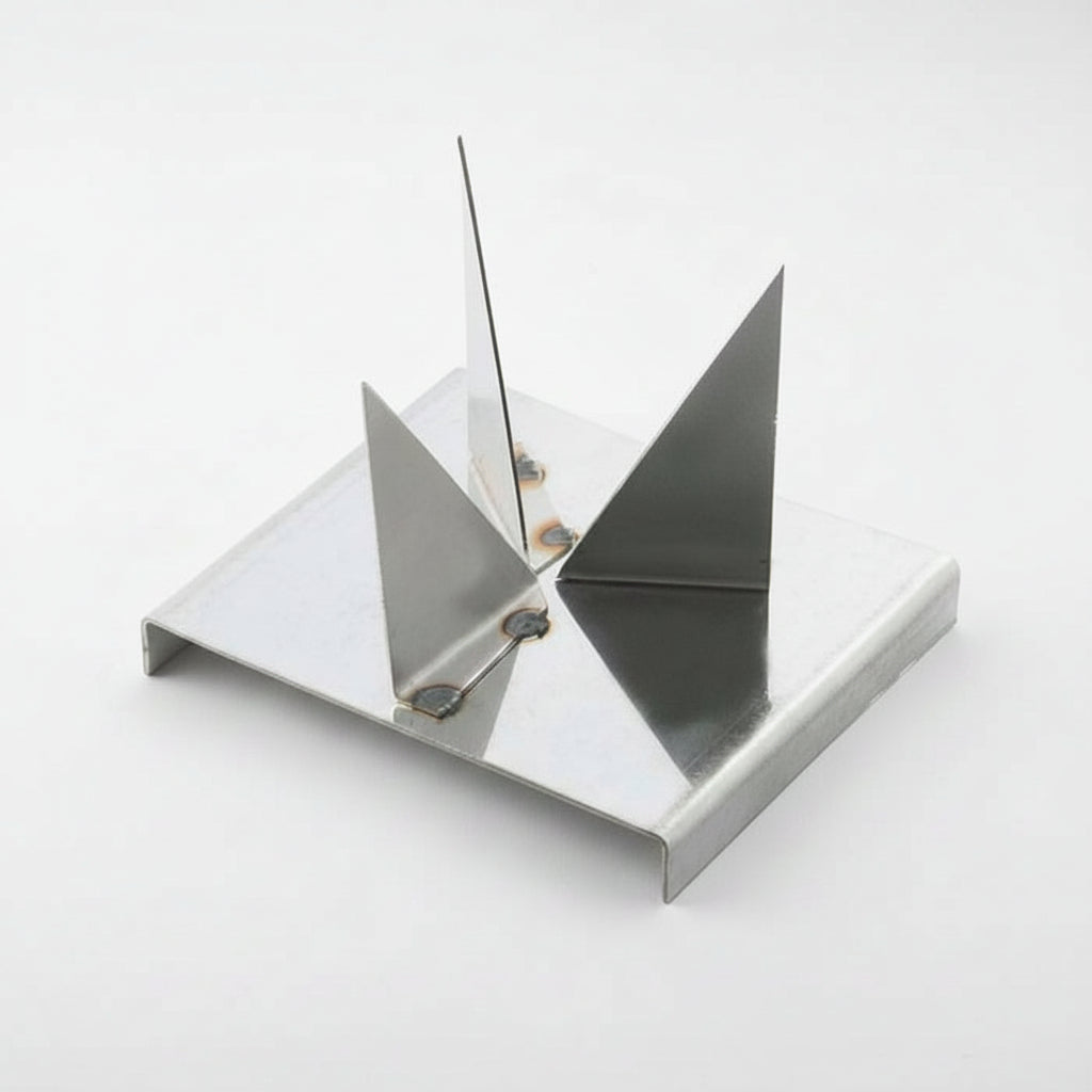 Metallic object with geometric design on a white background